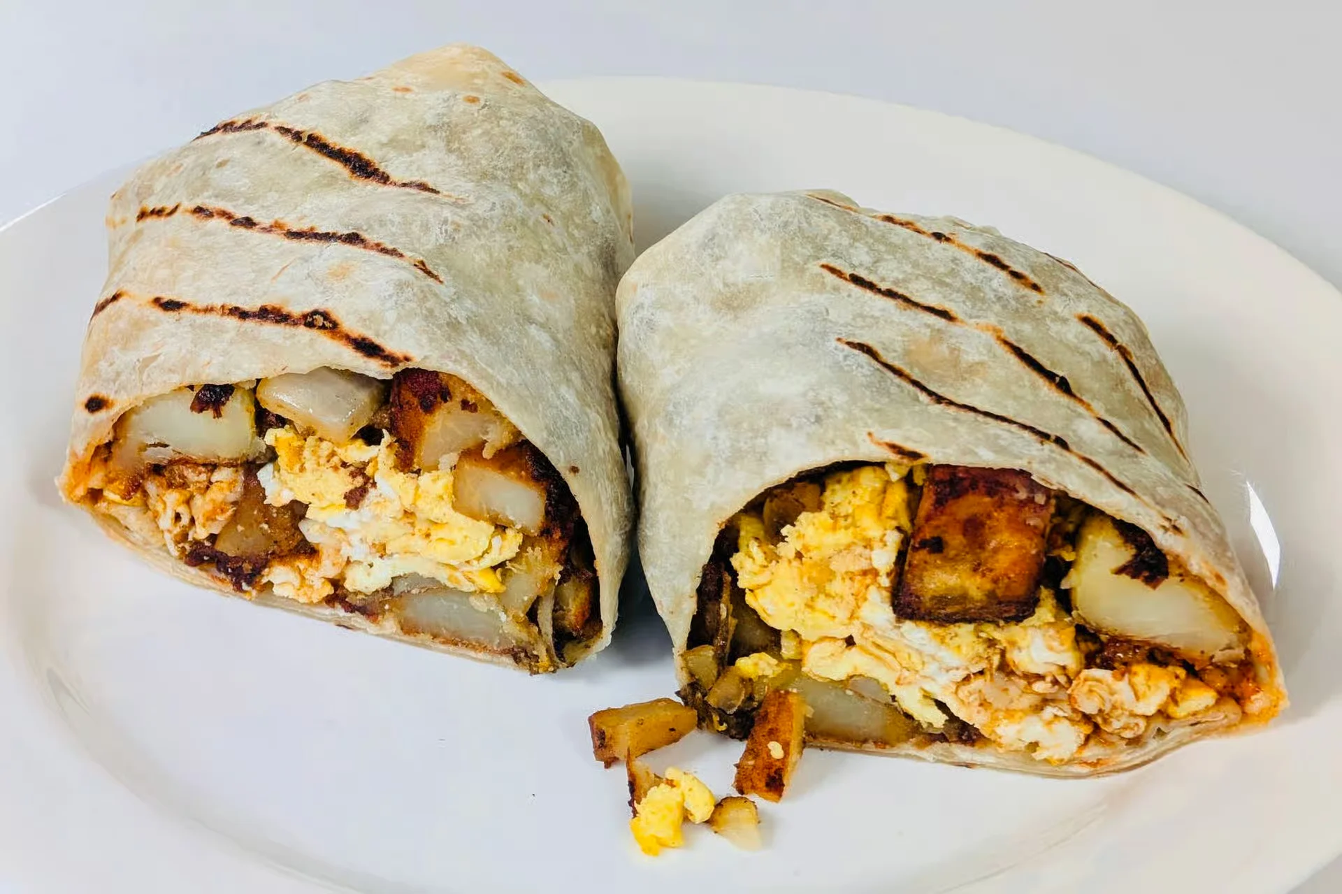 Breakfast Burrito - Eggs, potatoes, cheese with our New Mexico red chile sauce in a tortilla.